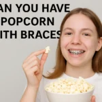 Bowl of popcorn with a braces warning sign, illustrating why popcorn is risky for orthodontic patients