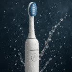 Modern waterproof electric toothbrush with sleek design and powerful cleaning performance placed near a bathroom sink.